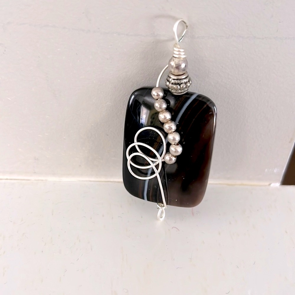 Black swirl stone pendant